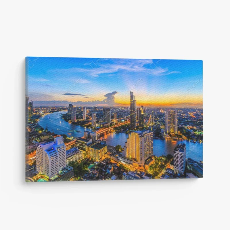 Quadro su tela tramonto urbano sul fiume: skyline illuminato