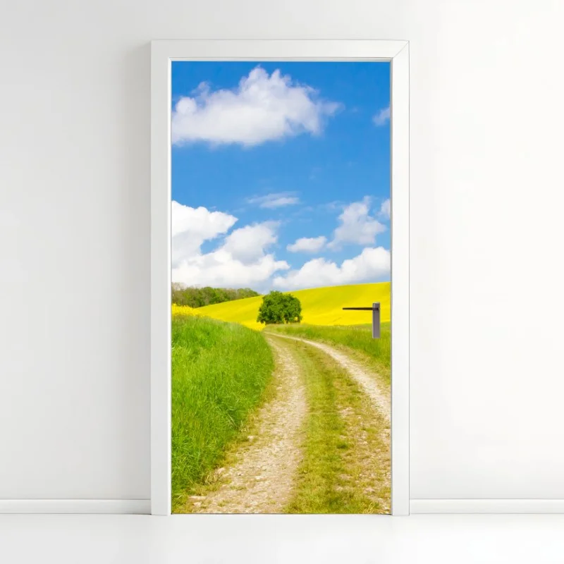 Adesivo per porta sentiero tra i campi di colza e prati verdi