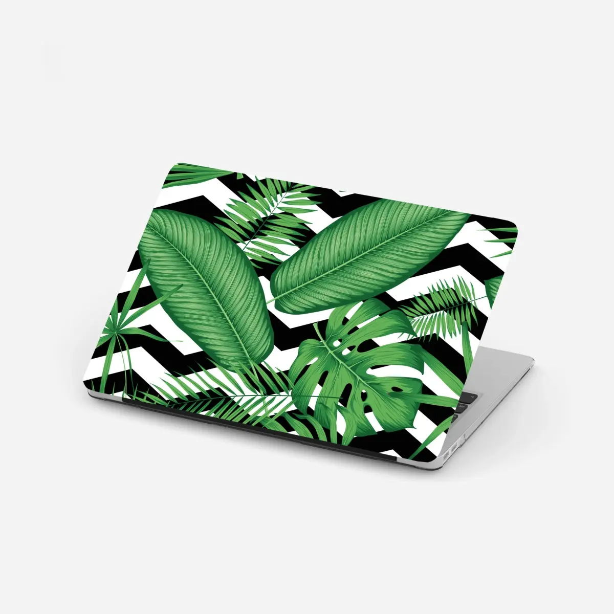 Adesivo per laptop grafica tropicale con foglie verdi su motivo zigzag • Wallissimo®