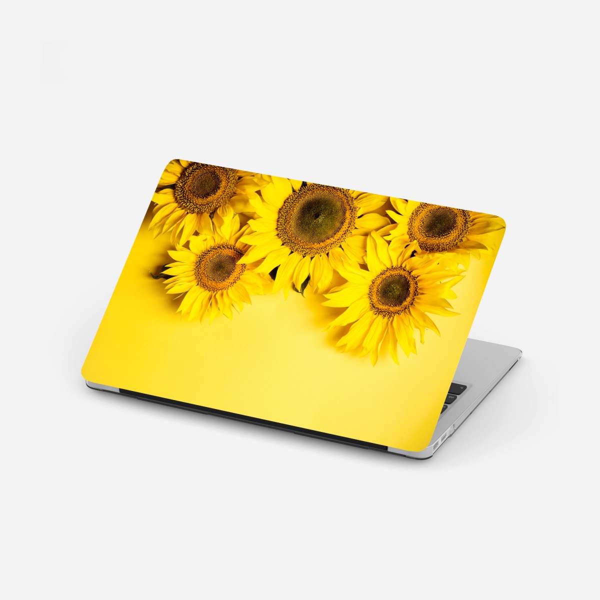 Adesivo per laptop girasoli su sfondo giallo vivace • Wallissimo®