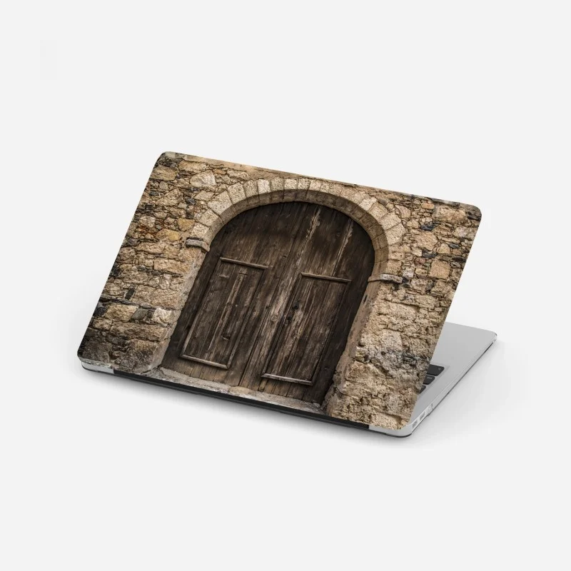Adesivo per laptop porta antica in legno su muro di pietra