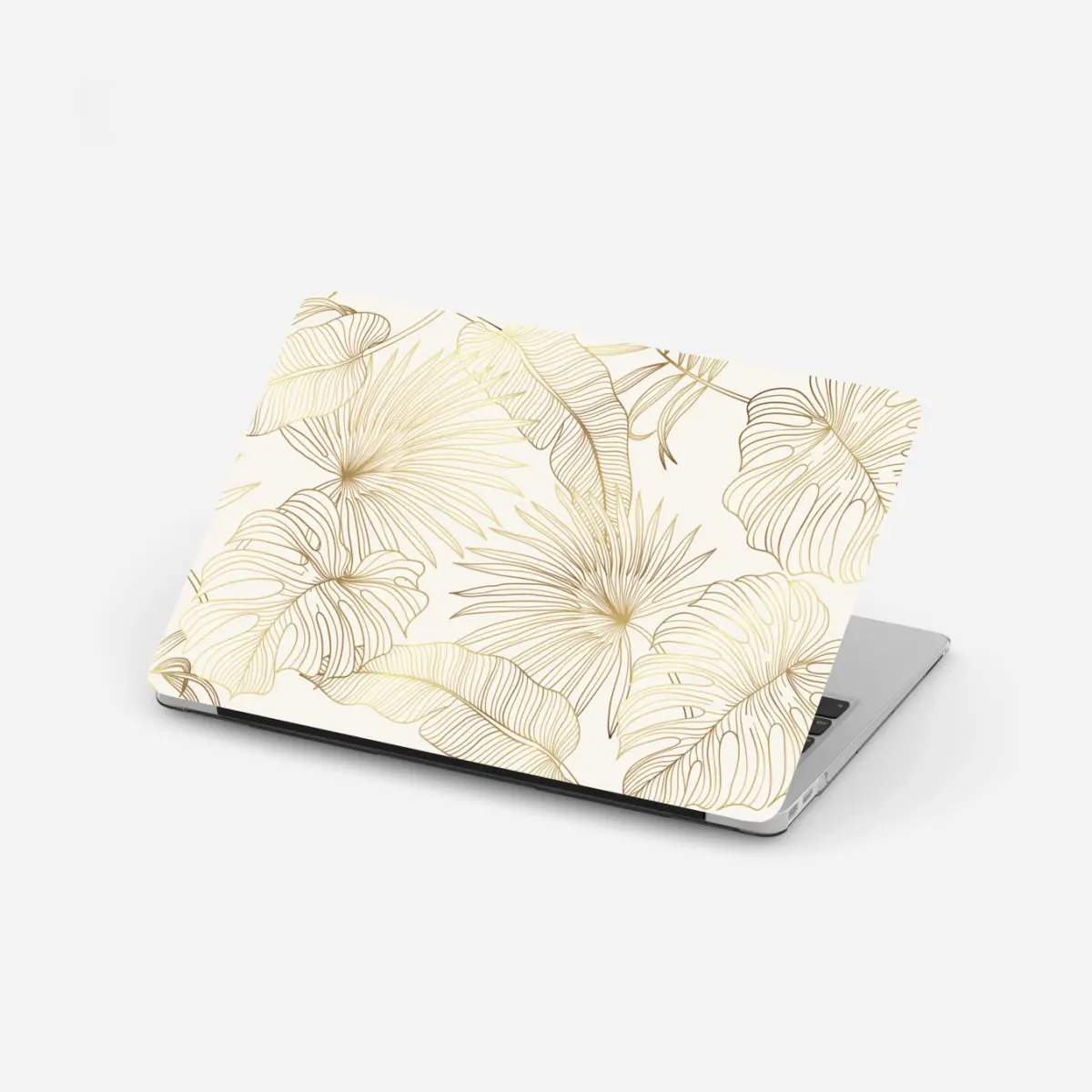 Adesivo per laptop fogliame tropicale dorato su fondo crema • Wallissimo®