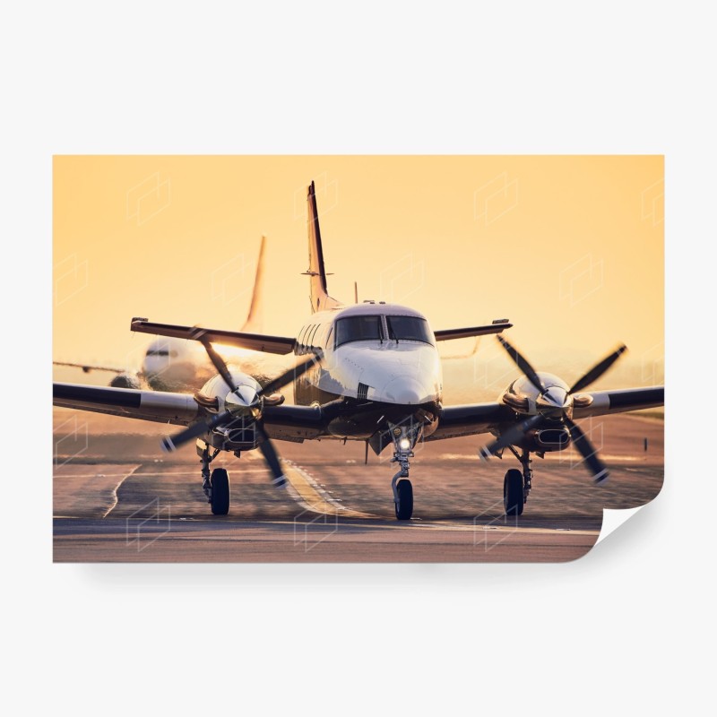 Carta da parati aereo bimotore al tramonto