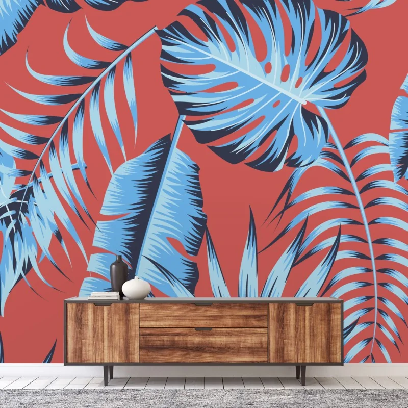 Carta da parati motivo foglie tropicali blu su sfondo corallo