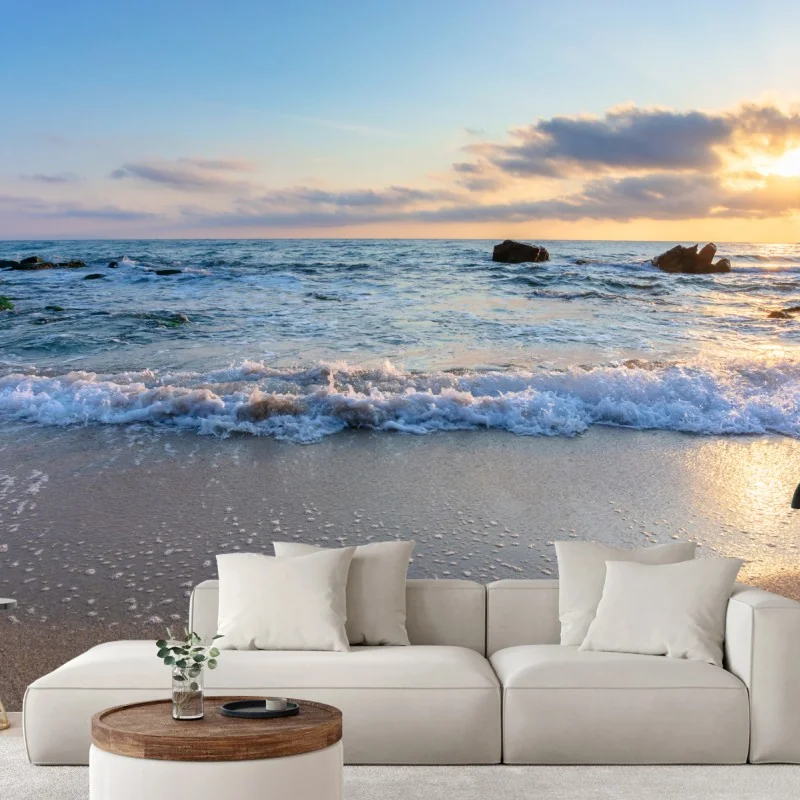 Carta da parati alba dorata sulla spiaggia rocciosa