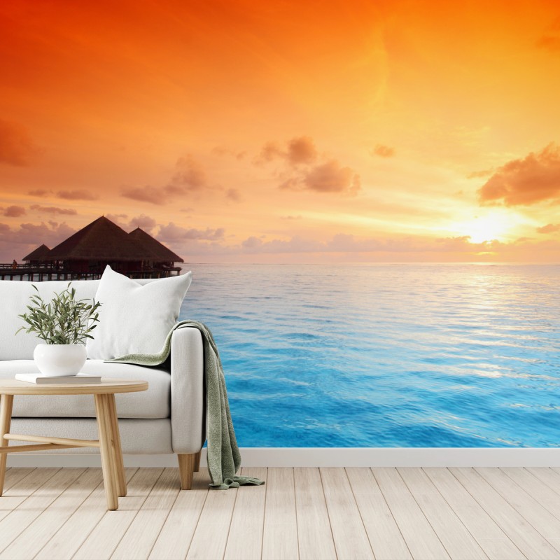 Carta da parati tramonto tropicale sul mare con bungalow sull'acqua